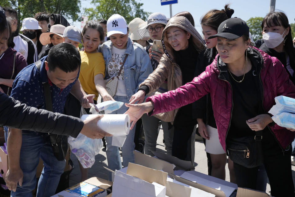 Members of Poland's Vietnamese community collect food donations, in Warsaw, Poland, Wednesday, May 15, 2024. A weekend fire in a shopping center in Warsaw dealt tragedy to many members of Poland's Vietnamese community. People lost entire livelihoods and say they don't know how they will manage to make a living. (AP Photo/Czarek Sokolowski)