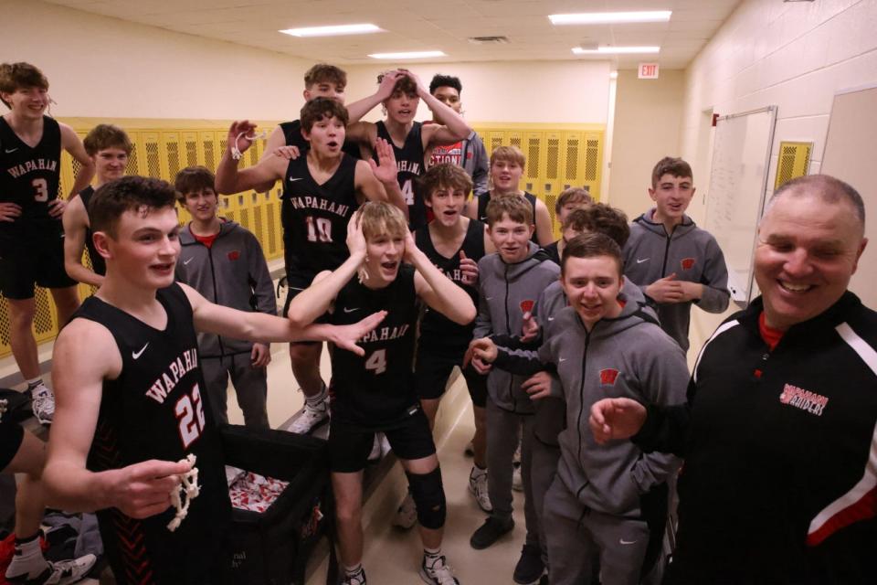 Wapahani boys basketball celebrates winning the program's first regional title after beating Carroll (Flora) at Lapel High School on Saturday, March 11, 2023.