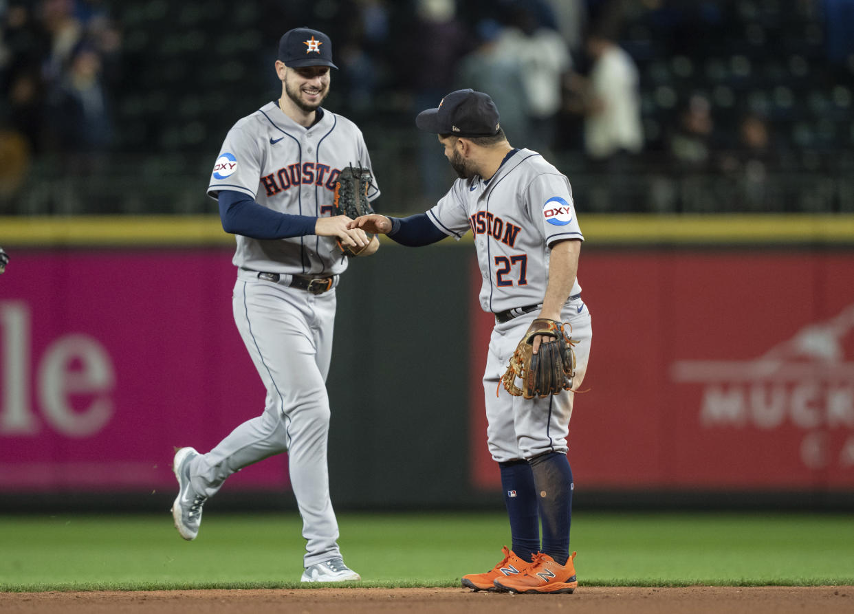Houston Astros right fielder Kyle Tucker, left, and second baseman Jose Altuve celebrate after a baseball game against the Seattle Mariners, Monday, Sept. 25, 2023, in Seattle. The Astros won 5-1. (AP Photo/Stephen Brashear)
