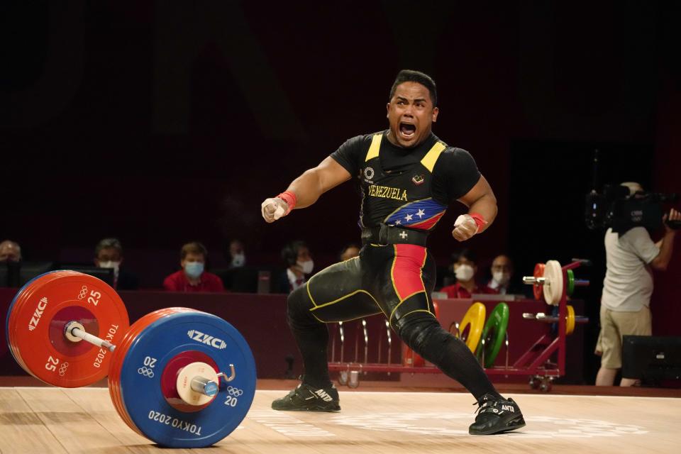 Keydomar Giovan Vallenilla Sanchez of Venezuela celebrates after the last lift in the men's 81kg weightlifting event, at the 2020 Summer Olympics, Saturday, July 31, 2021, in Tokyo, Japan. (AP Photo/Luca Bruno)