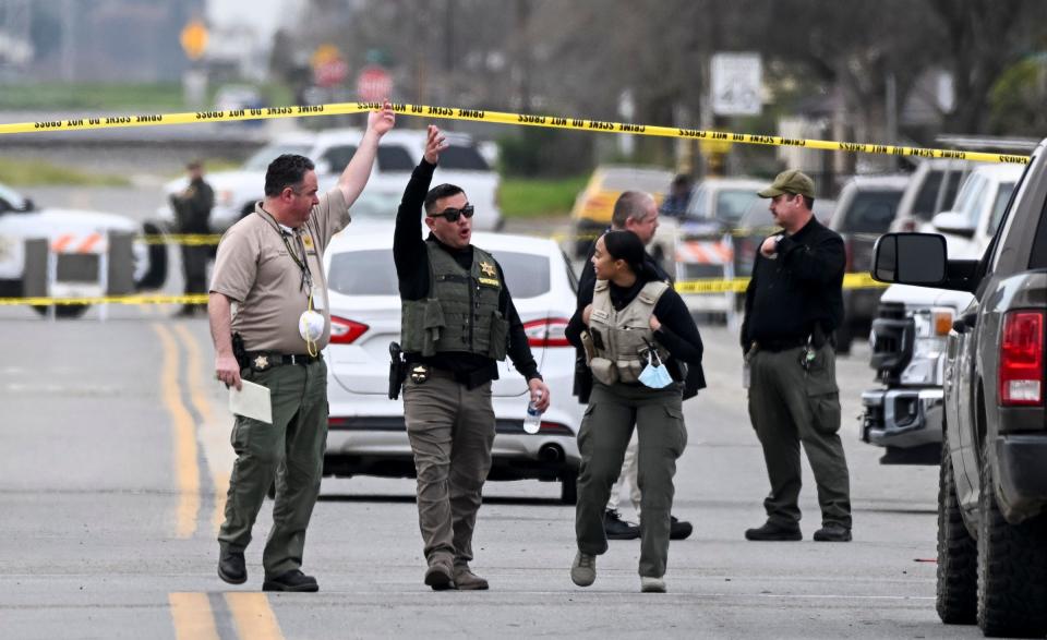 Investigators work Friday, February 3, 2023 on Avenue 308 in Goshen where one of two arrests were made for the January 16 homicide of six people nearby. The suspect was shot by an ATF agent but is expected to live. Another suspect was apprehended in Visalia, the other just blocks away from the crime scene. 