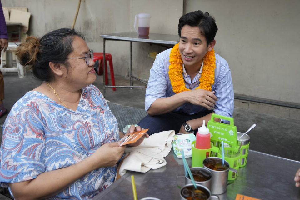 Leader of Move Forward Party Pita Limjaroenrat, right, introduces himself during an election campaign in Bangkok, Thailand, March 29, 2023. Three years ago, tens of thousands of mostly young people in Thailand took to the streets in heated demonstrations seeking democratic reforms. Now, with a general election coming in three weeks, leaders of the country’s progressive movement are hoping to channel the same radical spirit for change though the ballot box. (AP Photo/Sakchai Lalit)