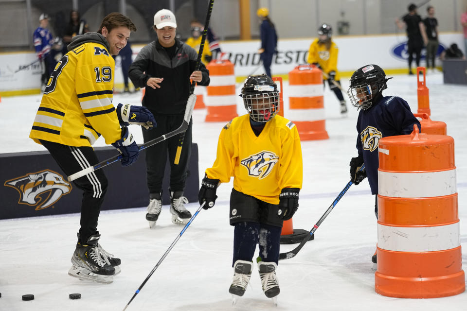 NHL draft prospect Adam Fantilli (19) gives instruction during a youth hockey clinic with other NHL draft prospects and members of the NHL Player Inclusion Coalition, Tuesday, June 27, 2023, in Nashville, Tenn. (AP Photo/George Walker IV)