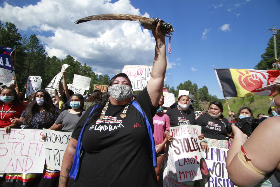 Native American protesters demonstrate in Keystone, S.D., ahead of President Donald Trump's visit to the memorial Friday, July 3, 2020. Protesters are advocating for the Black Hills to be returned to the Lakota people. (AP Photo/Stephen Groves)