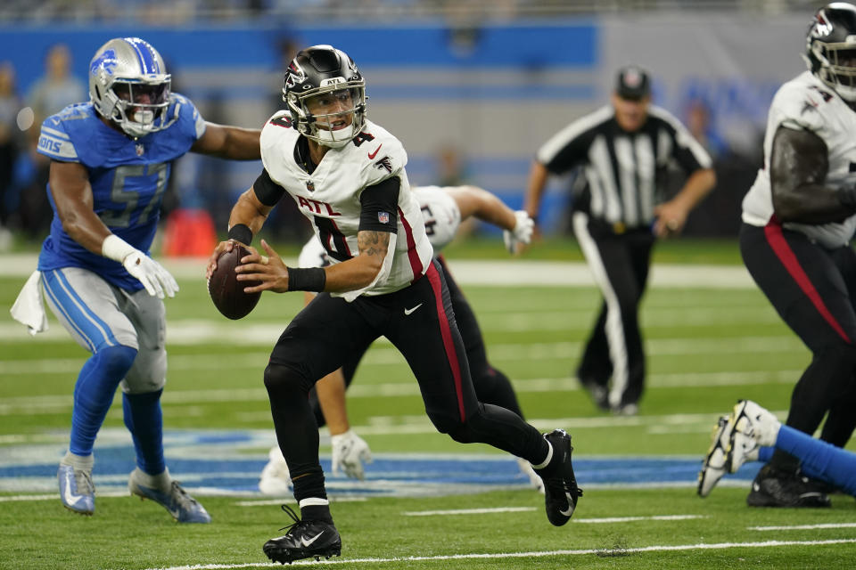 Atlanta Falcons quarterback Desmond Ridder (4) scrambles during the second half of a preseason NFL football game against the Detroit Lions, Friday, Aug. 12, 2022, in Detroit. (AP Photo/Paul Sancya)