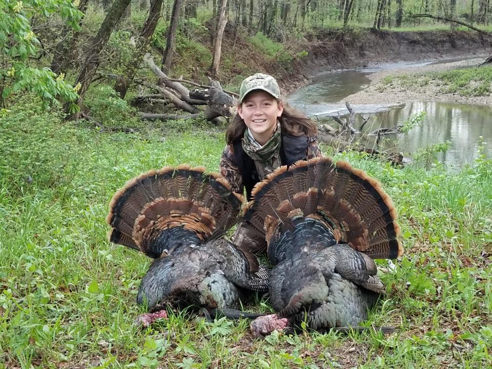 Brian Wooldridge's daughter, Sydney, with the two turkeys she shot in Kansas in April 2017.