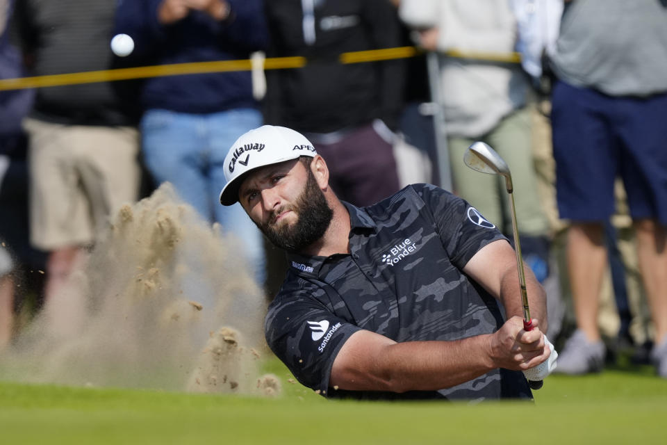 Spain's Jon Rahm hits out of a bunker on the 6th green on the first day of the British Open Golf Championships at the Royal Liverpool Golf Club in Hoylake, England, Thursday, July 20, 2023. (AP Photo/Jon Super)