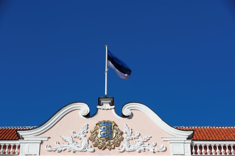 A national flag flutters over Estonian Parliament in Tallinn