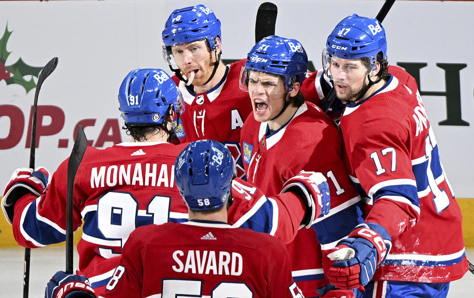 Montreal Canadiens' Jake Evans (71) celebrates with teammates after scoring against the Nashville Predators during the second period of an NHL hockey game in Montreal, Sunday, Dec. 10, 2023. (Graham Hughes/The Canadian Press via AP)