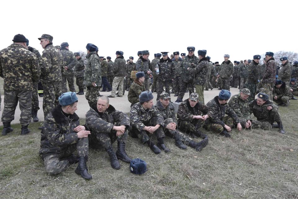Ukrainian service men wait at the Belbek airport in the Crimea region