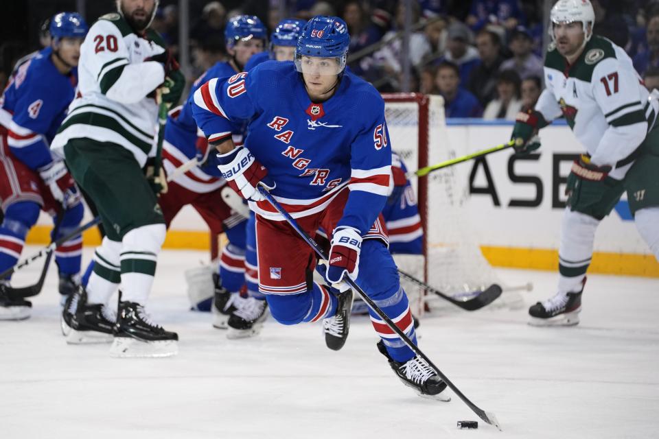 New York Rangers' Will Cuylle (50) gets control of the puck during the second period of an NHL hockey game against the Minnesota Wild, Thursday, Nov. 9, 2023, in New York. (AP Photo/Frank Franklin II)