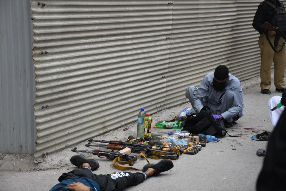 KARACHI, PAKISTAN - JUNE 29: Police officers inspect the site after gunmen attacked the Pakistani stock exchange building in Karachi, Pakistan on June 29, 2020. At least nine people were killed. The dead include four attackers, four Pakistan Stock Exchange security guards and a policeman, Muqaddas Haider, a city police chief, told reporters. At least seven people are also injured. (Photo by Sabir Mazhar/Anadolu Agency via Getty Images)