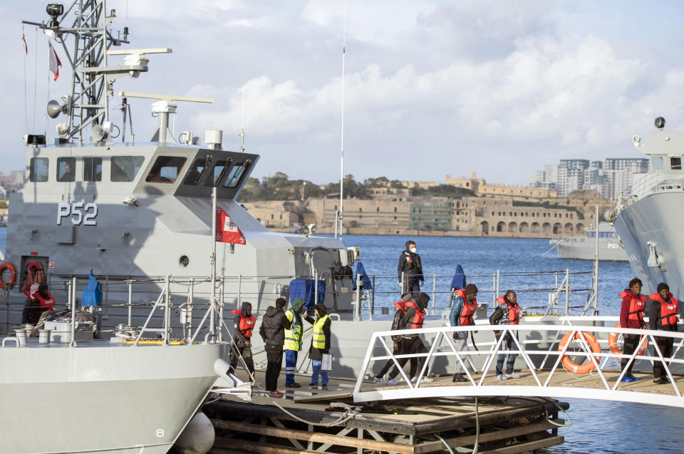 Migrants disembark at Hay Wharf, Pieta, Malta, Wednesday, Jan. 9, 2019. The 49 rescued migrants who were stranded at sea since last month were brought to Malta and then distributed among eight European Union countries. The deal, announced by Maltese Prime Minister Joseph Muscat, breaks a stalemate that began after 32 were rescued by a German aid group's vessel on Dec. 22. The other 17 were rescued on Dec. 29 by a different aid boat. Both Italy and Malta have refused to let private rescue ships bring migrants to their shores. (AP Photo/Rene Rossignaud)