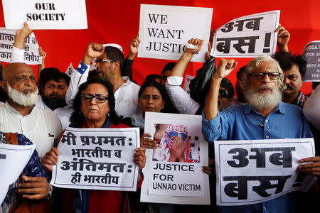 People shout slogans and hold placards during a protest against the rape of an eight-year-old girl, in Kathua, near Jammu and a teenager in Unnao, Uttar Pradesh state, in Mumbai, India April 13, 2018. REUTERS/Francis Mascarenhas