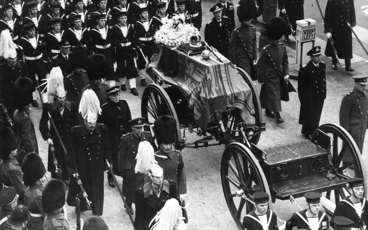 The coffin of King George VI lies on a gun carriage drawn by naval officers, and accompanied by men of the Household Cavalry on February 15, 1952 - Derek Berwin/Hulton Royals Collection