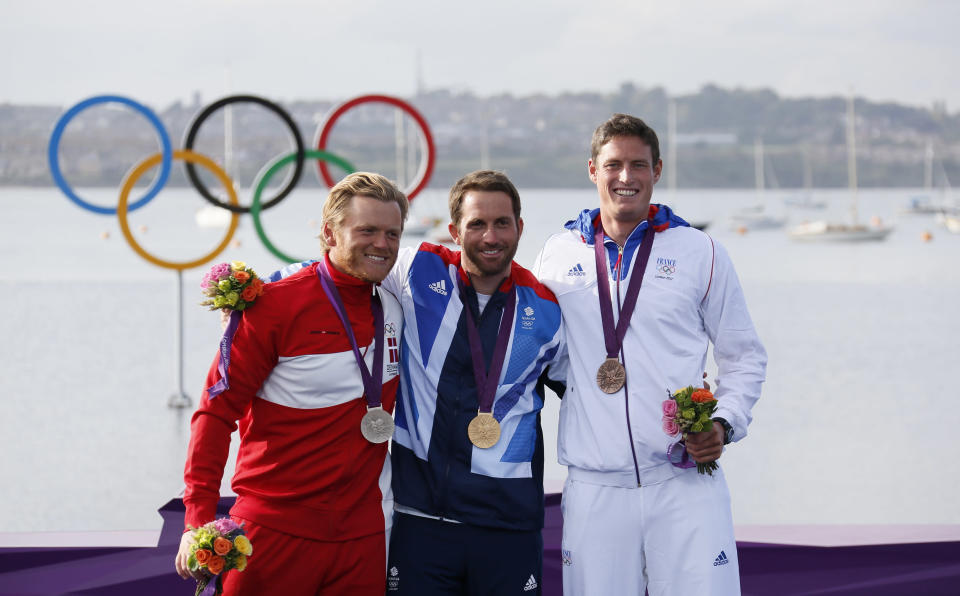 Medallists pose during the men's finn class one person dinghy (heavyweight) sailing medal race victory ceremony at the London 2012 Olympic Games in Weymouth and Portland, southern England August 5, 2012. From L-R: Silver medallist Denmark's Jonas Hogh-Christensen, gold medallist Britain's Ben Ainslie and bronze medallist France's Jonathan Lobert. REUTERS/Pascal Lauener (BRITAIN - Tags: SPORT YACHTING OLYMPICS) 