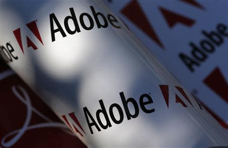 Adobe company logos are seen in this picture illustration taken in Vienna on July 9, 2013. REUTERS/Leonhard Foeger/Files