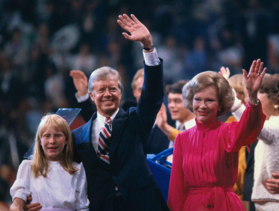 U.S. President Jimmy Carter with his wife, Rosalynn, and daughter, Amy, wave to supporters from the stage at the 1980 Democratic National Convention.