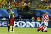 Referee Pedro Proenca of Portugal sends off Cameroon's Alexandre Song for a challenge on Croatia's Mario Mandzukic (on ground) during their 2014 World Cup Group A soccer match at the Amazonia arena in Manaus June 18, 2014. REUTERS/Murad Sezer (BRAZIL - Tags: SOCCER SPORT WORLD CUP TPX IMAGES OF THE DAY)