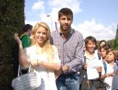 Shakira met up with her Barcelona footballer boyfriend Gerard Pique. The happy couple kissed and cuddled while having lunch at 'Jardin de las Abadesas' restaurant and greeted school children at a nearby school.