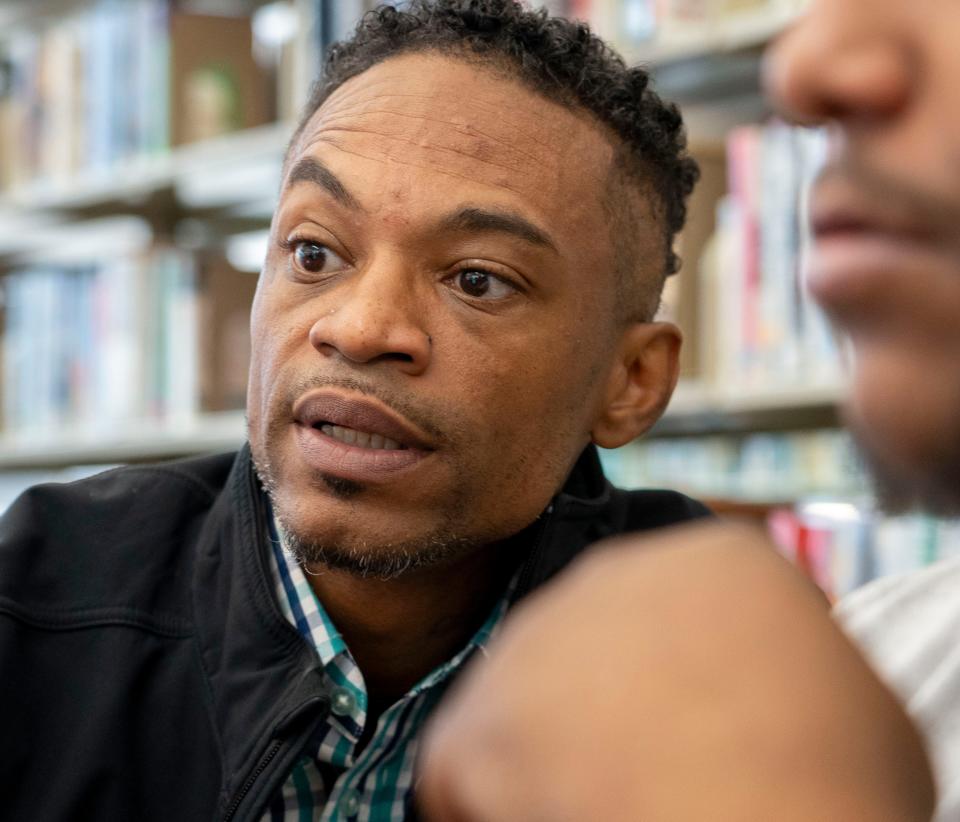 Daniel Mallory, a life coach with the Peacemakers program, works with a fellow Thursday, Sept. 7, 2023, at the Central Library in Indianapolis. The Indy Peace Fellowship aims to reduce gun violence by connecting high risk individuals with resources in the community.