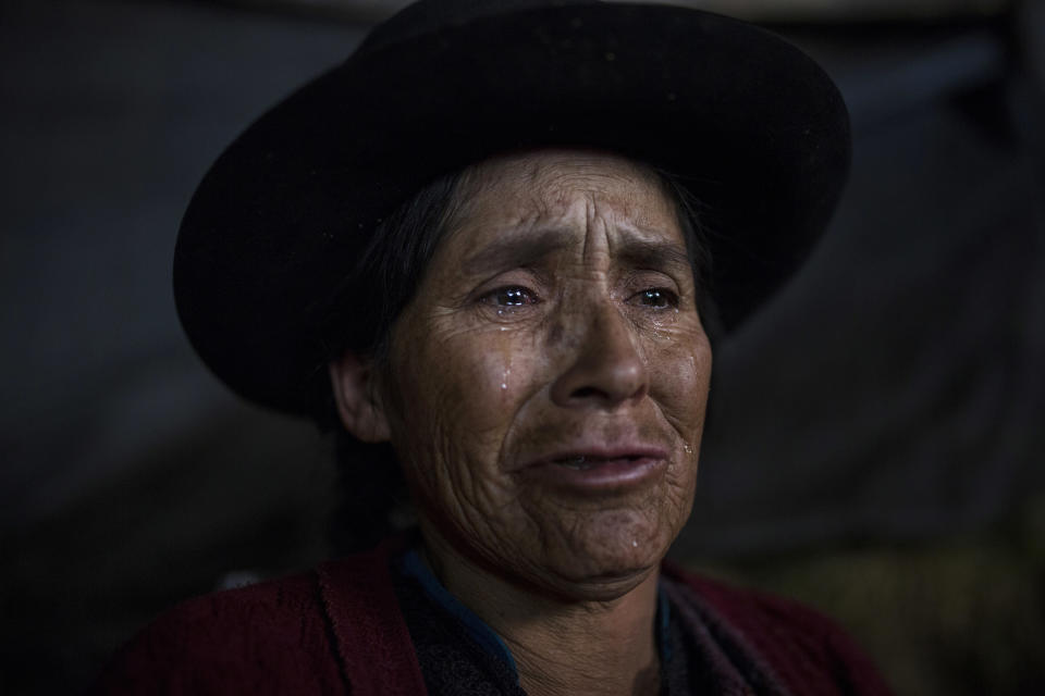 En imagen del 15 de agosto de 2018, Antonia Yupanki Tineo, de 58 años, llora cerca del ataúd de su tío Alejandro Tineo, que murió a manos de las guerrillas del grupo Sendero Luminoso en 1984, durante el sepelio en Quinuas, en la provincia peruana de Ayacucho. En los últimos 16 años, los restos óseos de 3.823 personas desaparecidas han sido exhumados en la nación andina. (AP Foto/Rodrigo Abd)