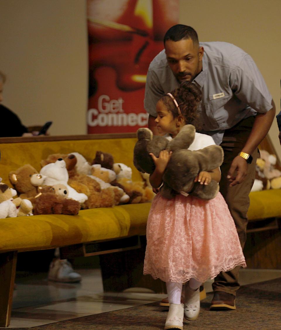 Brennon Holdman follows his daughter after she adopts a stuffed bear after her adoption was finalized on Nov. 18 at Lubbock Impact.