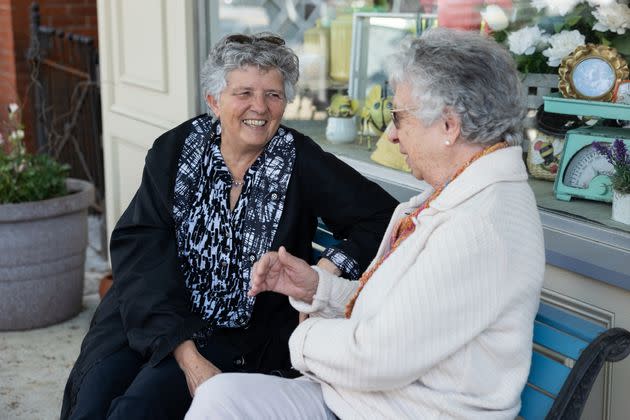 Friends Linda Dapcic (left), 71, and Alicia Miller, 85, sit together in Lititz, Pennsylvania. Miller said her family runs a poultry farm that employs migrants, but even so she doesn't want to see immigration get out of control.