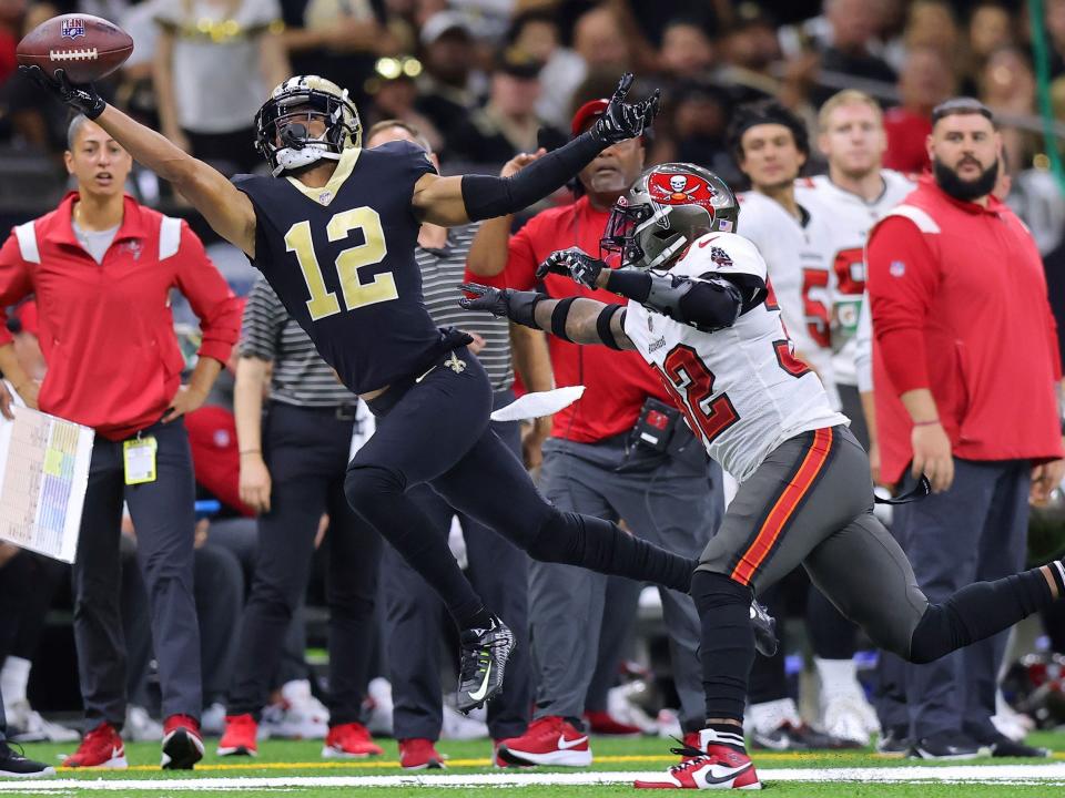 Chris Olave attempts to make a catch against the Tampa Bay Buccaneers.