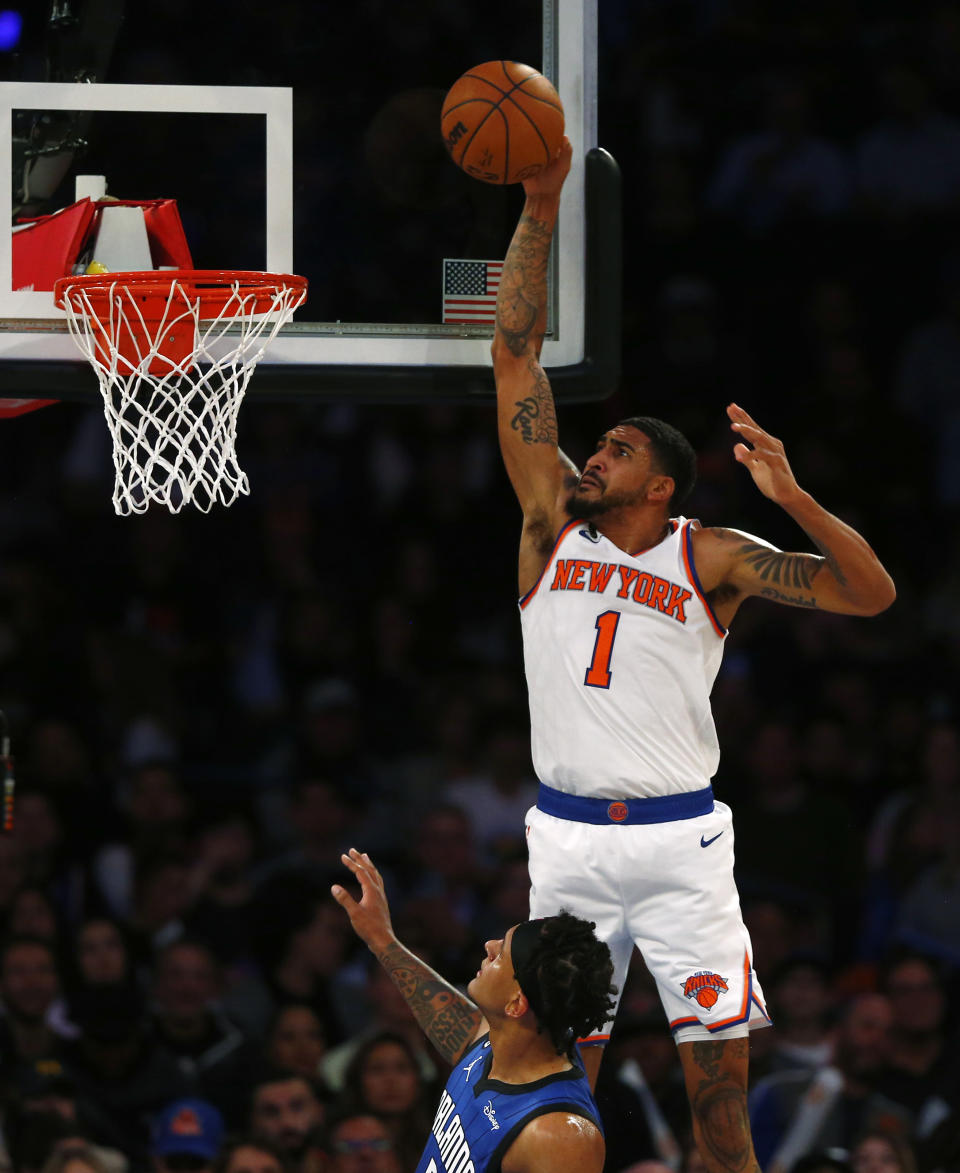 New York Knicks forward Obi Toppin (1) dunks over Orlando Magic forward Paolo Banchero during the first half of an NBA basketball game Monday, Oct. 24, 2022, in New York. (AP Photo/John Munson)