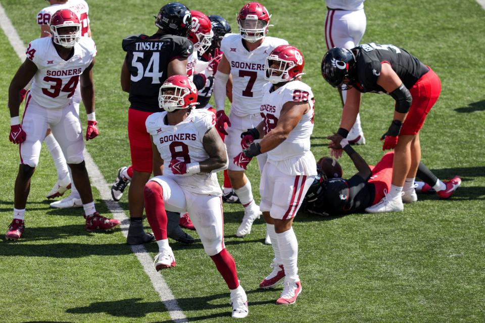 OU defensive lineman Jonah Laulu (8) celebrates a sack on Cincinnati quarterback Emory Jones (5) during the second half of a 20-6 win Saturday at Nippert Stadium in Cincinnati.