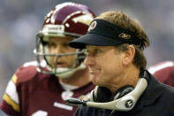 FILE - Washington Redskins coach Steve Spurrier, right, looks out at the field during the final minutes of the Redskins' 27-20 loss to the Dallas Cowboys in Irving, Texas, in this Thursday Nov. 28, 2002, file photo. Redskins quarterback Danny Wuerffel is at rear. Spurrier was 12-20 in two years at Washington before he walked away. (AP Photo/Donna McWilliam, File)