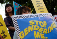 Protesters hold placards during a rally against harassment at Shinjuku shopping and amusement district in Tokyo, Japan, April 28, 2018. Picture taken April 28, 2018. REUTERS/Issei Kato