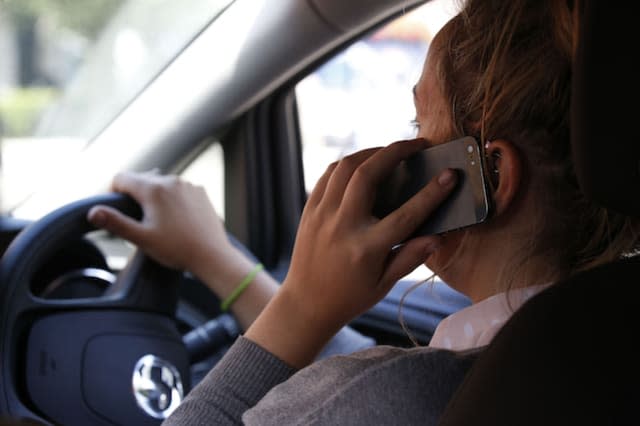 NOTE POSED BY MODEL File photo dated 13/08/14 of a woman using a mobile phone while driving. Half of Britons (50\%) believe all use of mobiles while driving is dangerous, Government research has found.