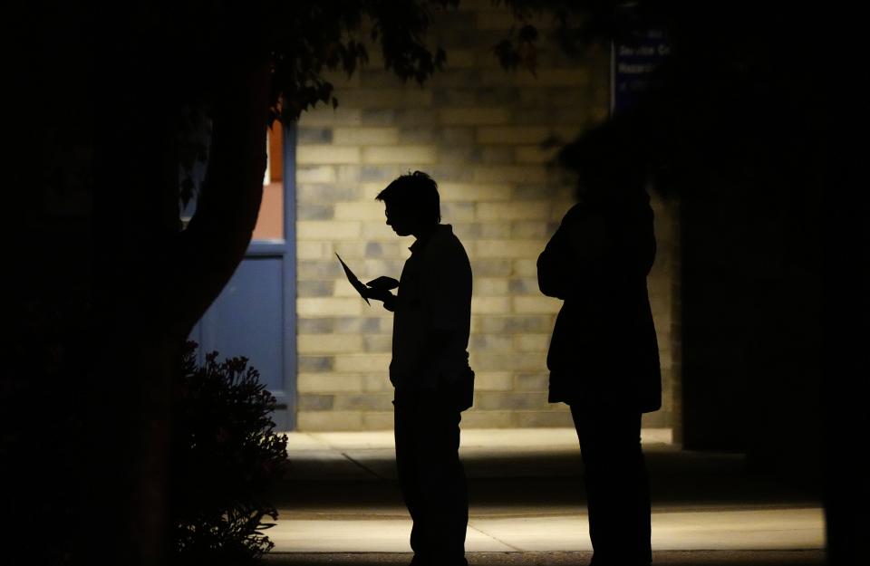 People arrive before the polls open to line up on Election Day in Gilbert, Arizona.