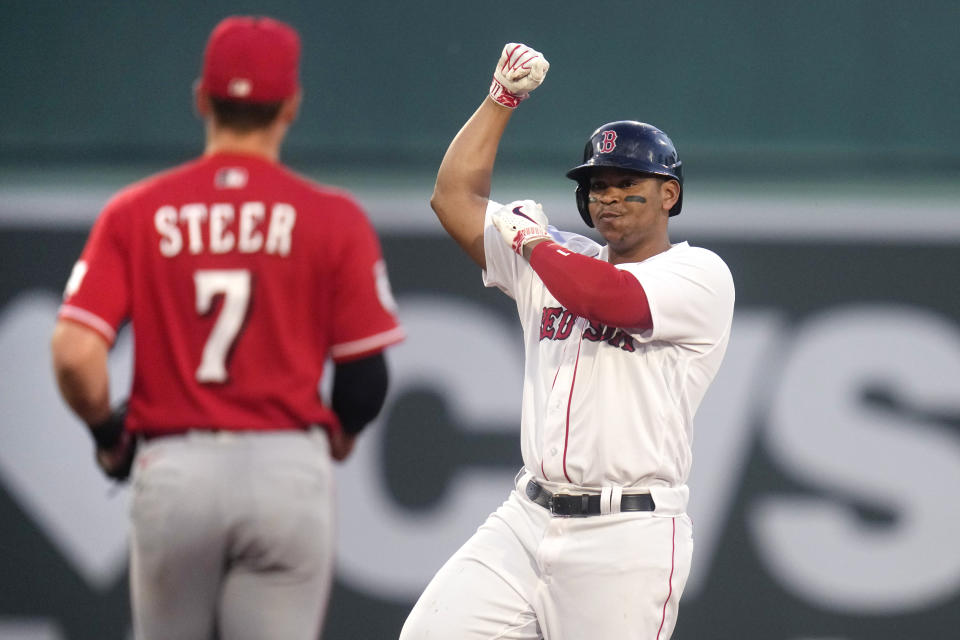 Boston Red Sox's Rafael Devers celebrates his RBI double during the third inning of the team's baseball game against the Cincinnati Reds at Fenway Park, Wednesday, May 31, 2023, in Boston. At left is Reds first baseman Spencer Steer. (AP Photo/Charles Krupa)