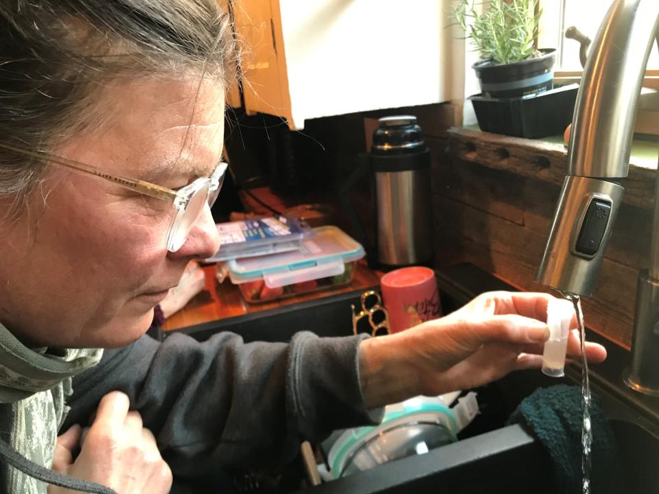 Kari Rasmussen, of Grosse Pointe Park, who did not trust her tap water, is shown taking a sample in her kitchen prior to testing her tap water and finding it was free of contaminants on May 4, 2023.