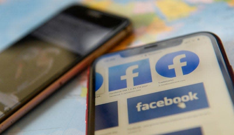 FILE PHOTO: Facebook logos are seen on a mobile phone in this picture illustration taken December 2, 2019. REUTERS/Johanna Geron/Illustration