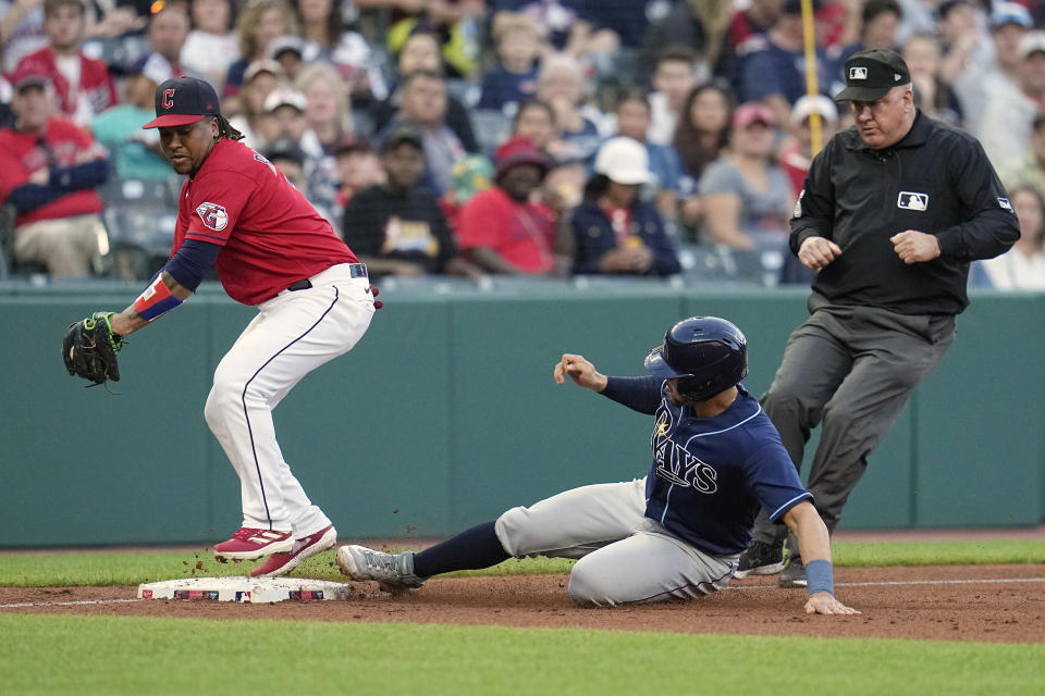 Tampa Bay Rays' Rene Pinto advances to third base next to Cleveland Guardians third baseman José Ramírez, left, on a wild pitch during the third inning of a baseball game Friday, Sept. 1, 2023, in Cleveland. (AP Photo/Sue Ogrocki)