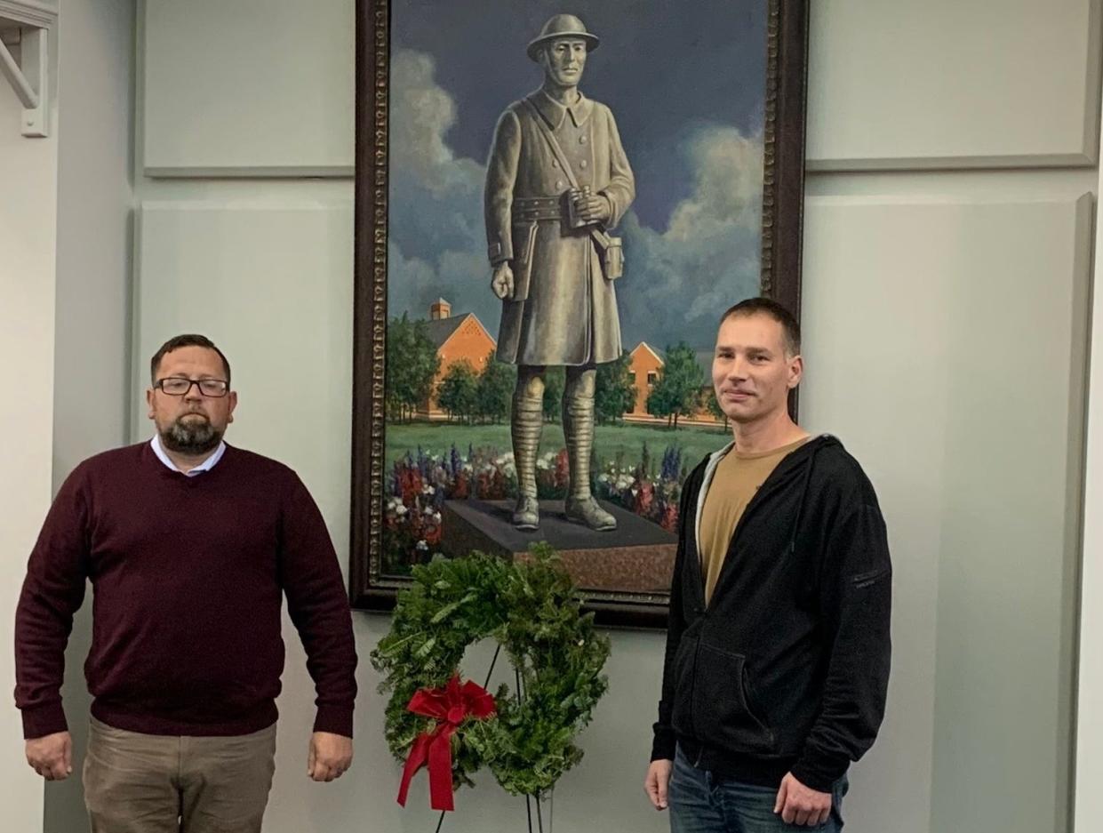 Stow City Councilman Jeremy McIntire, left, and Chief Petty Officer Adam Rossman, presented and laid the remembrance wreath for the Doughboy during a Veterans Day ceremony for Wreaths Across America.