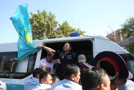 Law enforcement officers detain opposition supporters during a rally in Almaty