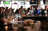 FILE - In this Wednesday, Dec. 16, 2020 file photo, patrons pack Alibi Drinkery in Lakeville, Minn. Monet Zarza, owner of Alibi Drinkery in Lakeville, is part of a group of businesses that reopened in defiance of Gov. Tim Walz's order that closed for indoor service for bars and restaurants. (Aaron Lavinsky/Star Tribune via AP)