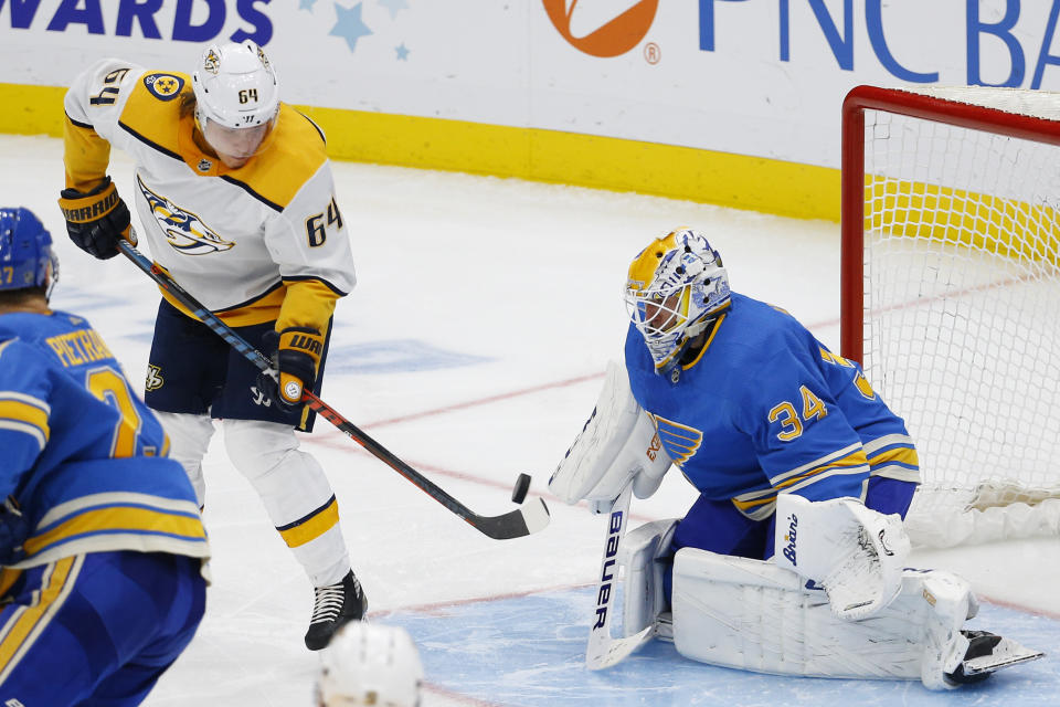 Nashville Predators' Mikael Granlund, of Finland, deflects a shot in front of St. Louis Blues goaltender Jake Allen during the third period of an NHL hockey game Saturday, Feb. 15, 2020, in St. Louis. (AP Photo/Billy Hurst)