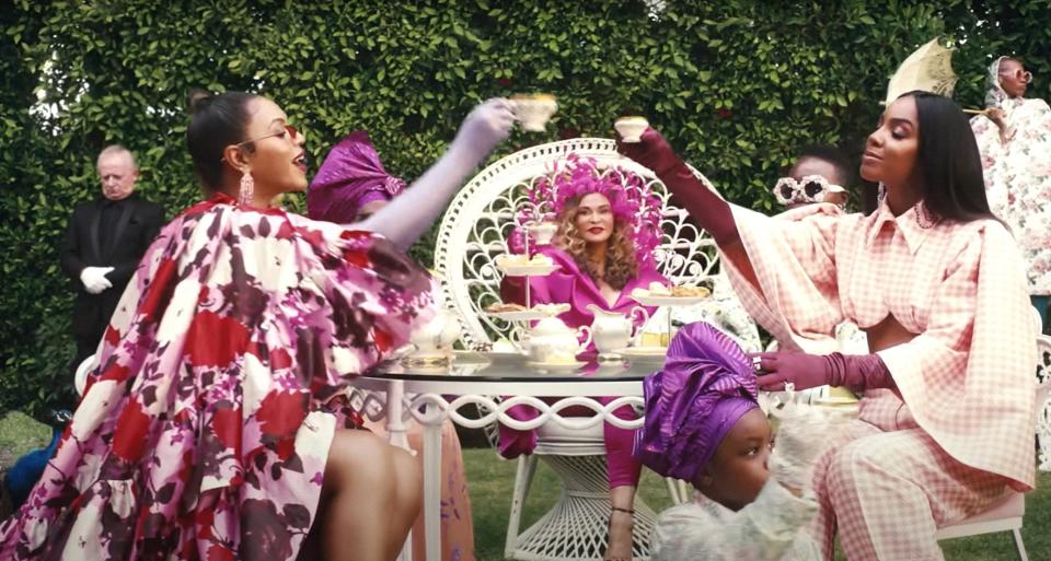 Beyoncé toasting tea cups with Kelly Rowland as Tina Knowles looks on in the background