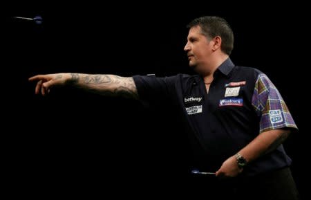 FILE PHOTO: Gary Anderson in action at the Betway Premier League Darts 2016 competition at the Motorpoint Arena in Cardiff, Britain, March 31, 2016. REUTERS/Action Images/Peter Cziborra/File Photo