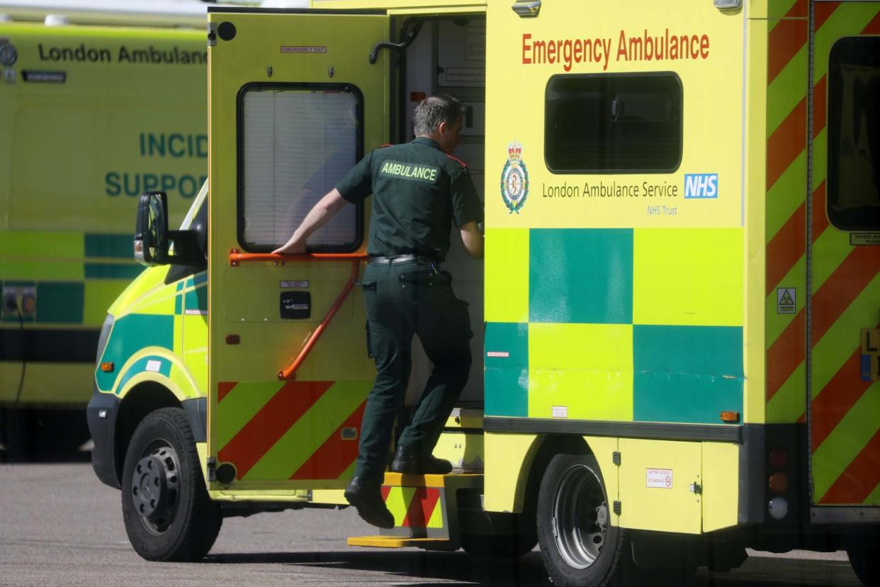 Paramedics and a ambulance is seen outside NHS Nightingale Hospital (REUTERS)