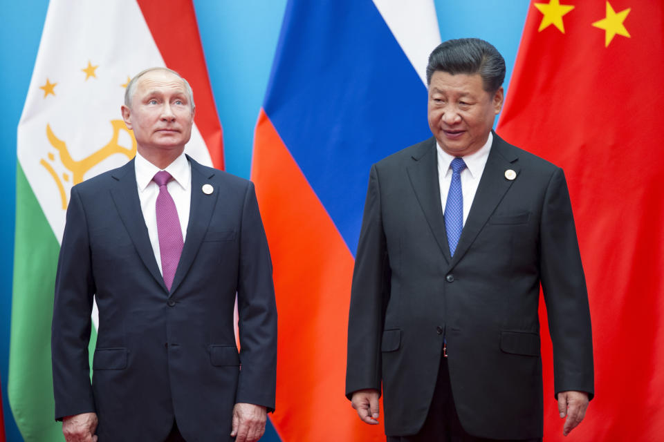 FILE - In this Sunday, June 10, 2018 file photo, Chinese President Xi Jinping, right, and Russian President Vladimir Putin pose for a photo at the Shanghai Cooperation Organization (SCO) Summit in Qingdao in eastern China's Shandong Province. Xi is traveling to Vladivostok, in the Russian Far East, on Tuesday Sept. 11, and Wednesday Sept. 12, 2018, for an economic conference where he’s expected to meet with Putin, while China joins vast Russian war games for the first time. (AP Photo/Alexander Zemlianichenko, File)