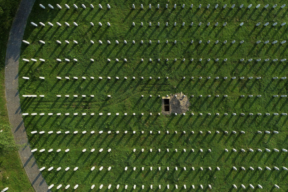 In this photo taken with a drone, an aerial view of the Srebrenica Genocide Memorial Center and the newly dug grave is seen in Potocari, Bosnia, Monday, July 10, 2023. Newly-identified Srebrenica massacre victims are reburied annually on July 11. (AP Photo/Armin Durgut)