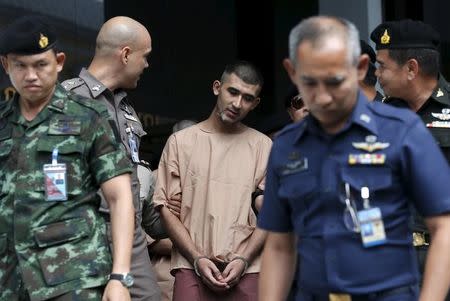 A suspect of the August 17 Bangkok blast, who has been referred to as Yusufu Mieraili, is escorted by soldiers and prison officers as he leaves the military court in Bangkok, Thailand, November 24, 2015. REUTERS/Chaiwat Subprasom