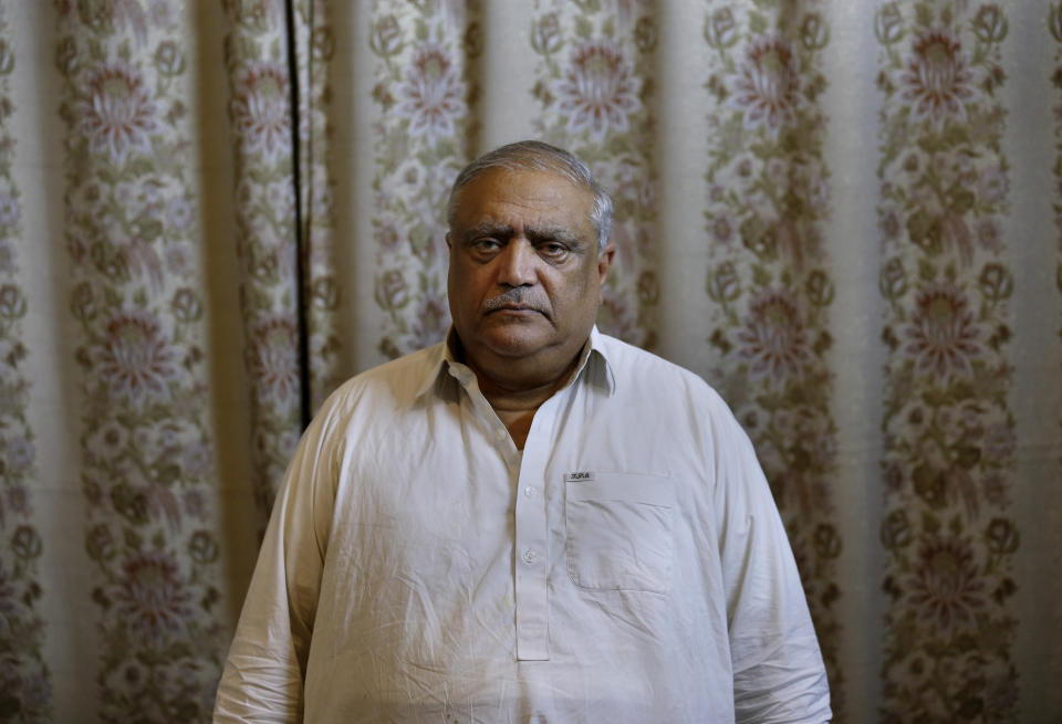 Professor Mohammad Ismail, father of a Pakistani human rights activist Gulalai Ismail, poses for photograph at his home in Islamabad, Pakistan, Thursday, Oct. 17, 2019. A dozen plainclothes Pakistani security forces attempted to raid the former home of Gulalai Ismaila who recently fled to the United States seeking asylum. Gulalai's elderly parents say they were ordered to come outside "just to talk," but refused. Raids like the one early Thursday in the capital of Islamabad are part of an expanding push by Pakistan's security services to crack down on anyone who voices criticism of their activities. (AP Photo/Anjum Naveed)